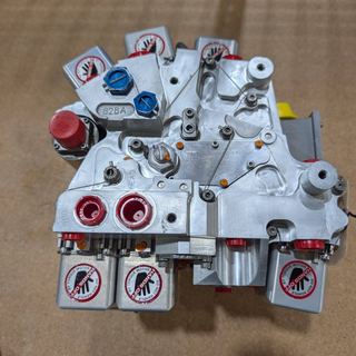 Fuel control assembly with torque-motor handling covers